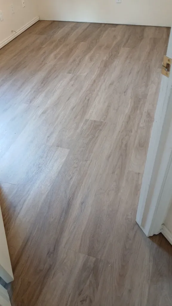 Close view of wood-look vinyl plank flooring installed in room
